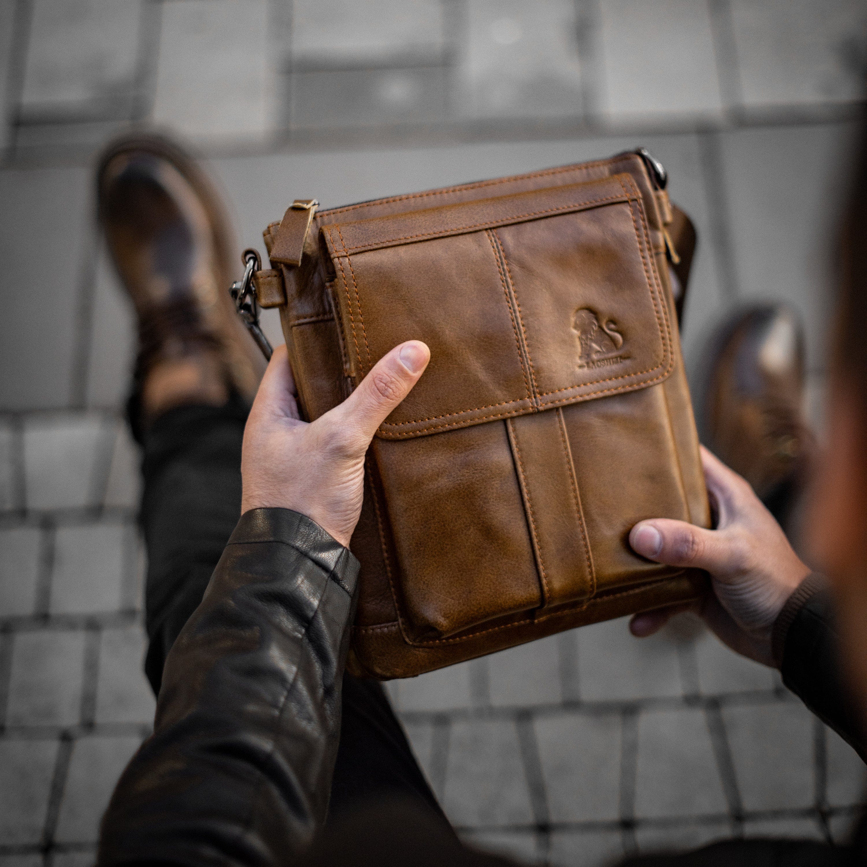 Muška kožna torba Lion  - Svetla Braon Boja - Muškarac drži u rukama torbu i izbliza pokazuje prednju stranu