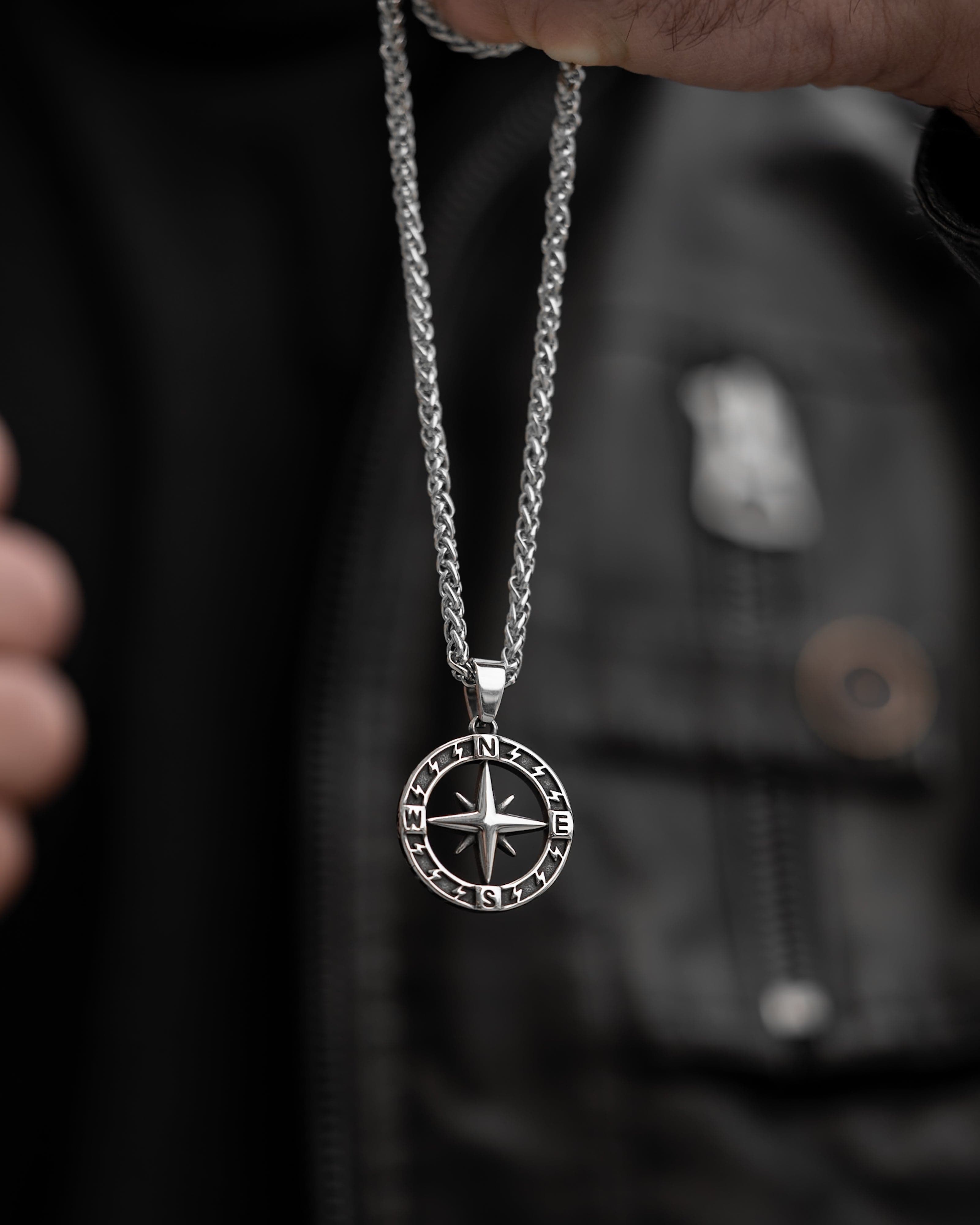 Muskarac drzi musku ogrlicu Stellar North. Privezak i lanac HIRUSKI CELIK, srebrna boja, Najbolja cena i prodaja u Srbiji, model 27