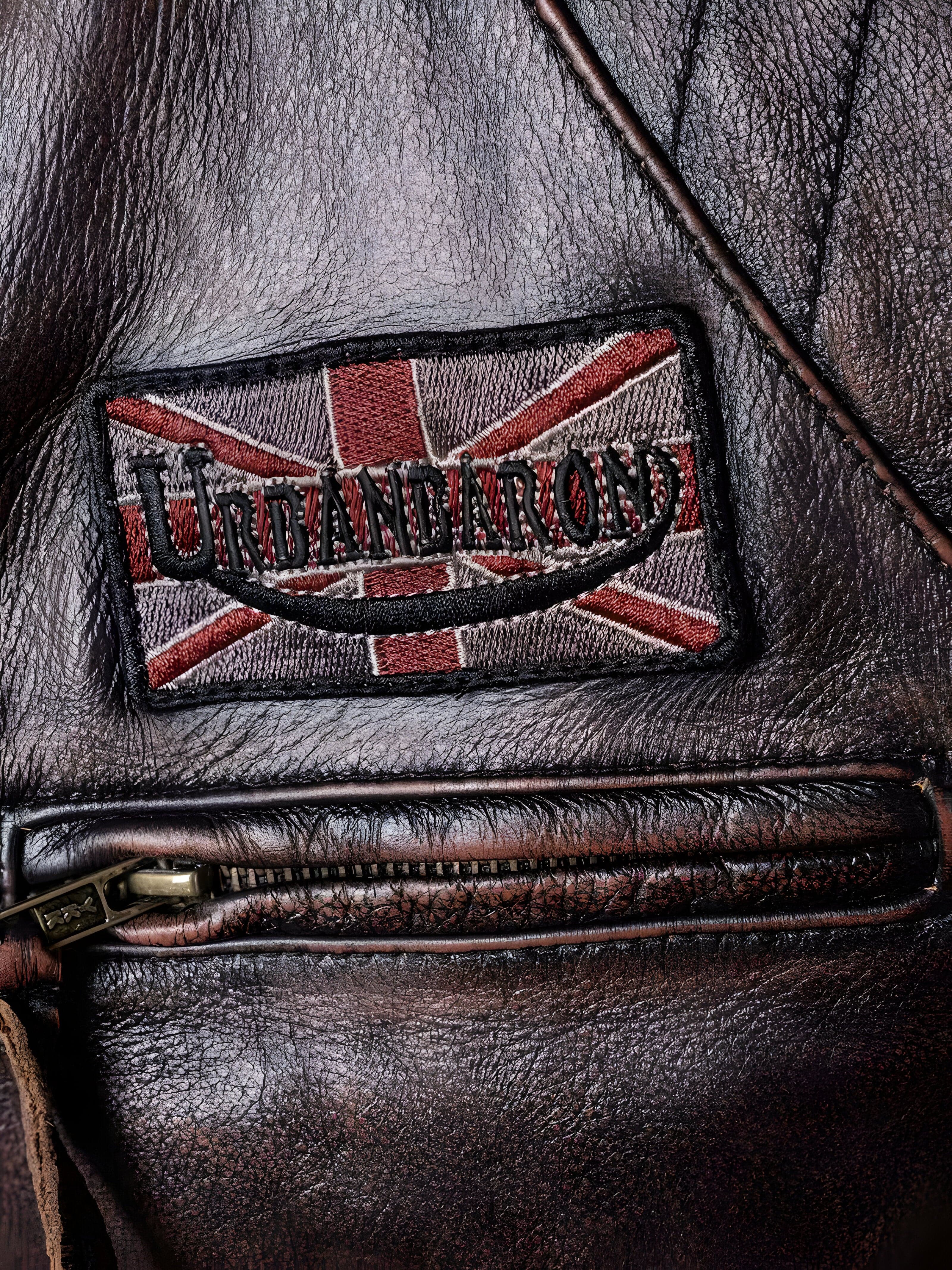 Detalj izbliza. Muška jakna Canyon Brown braon makro prikaz strukture prirodne kože i završne obrade štepova